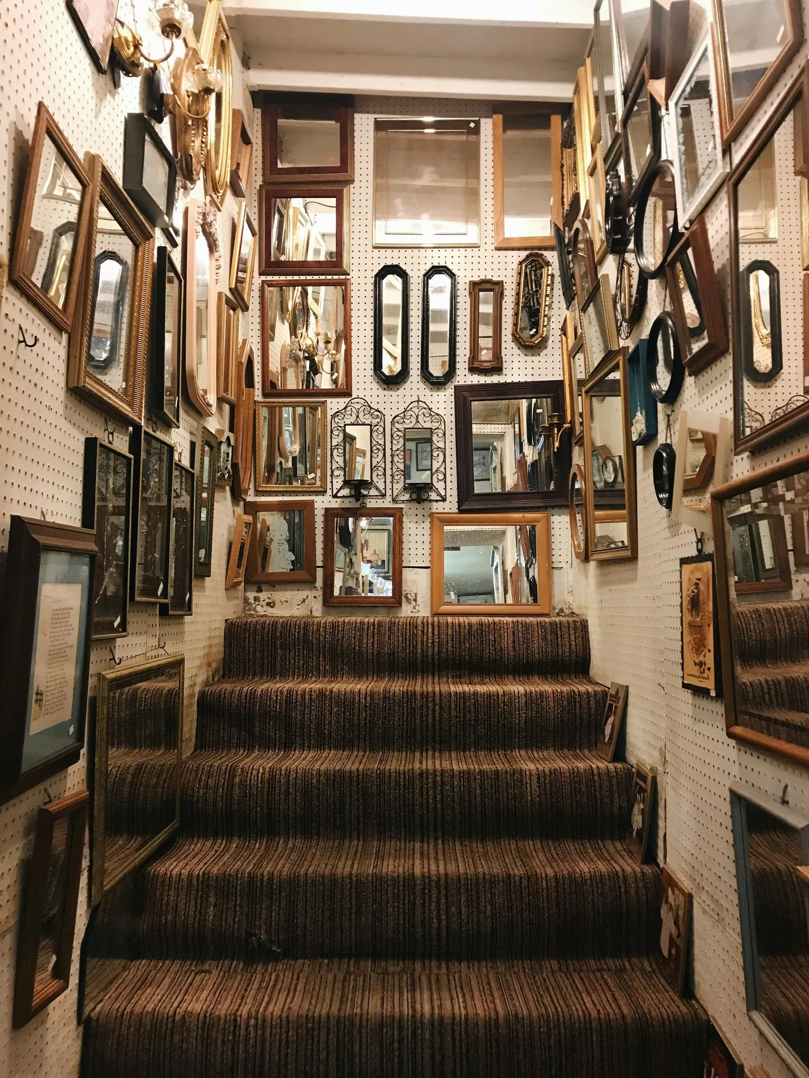 A staircase in a family home lined with framed photographs