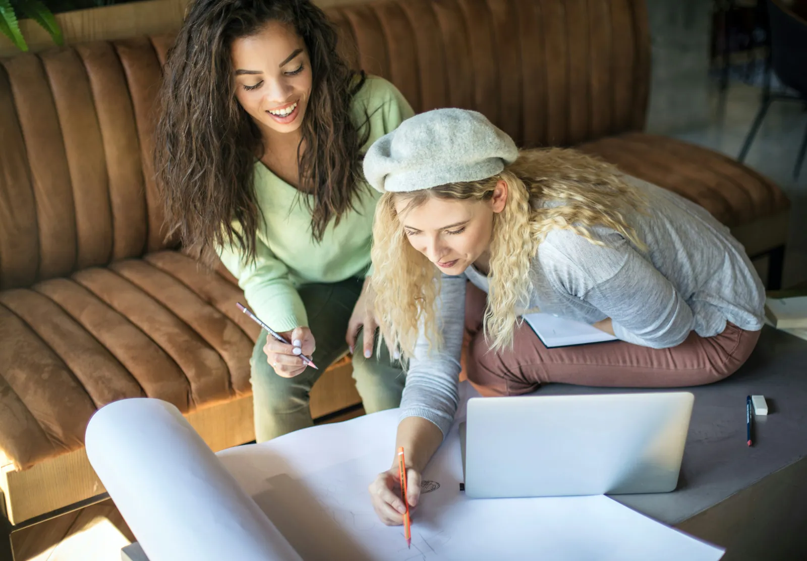 A parent and child working through homework together at a wooden table