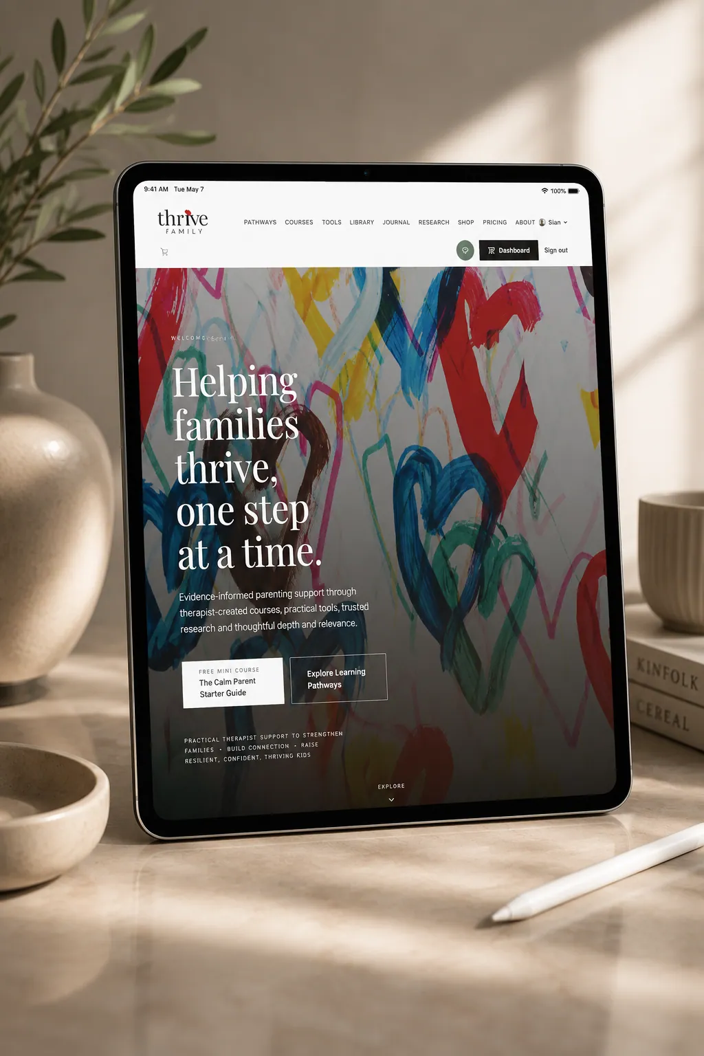 Free Calm Parent Starter Kit shown on iPad in a warm tabletop setting with the Thrive Family homepage on screen