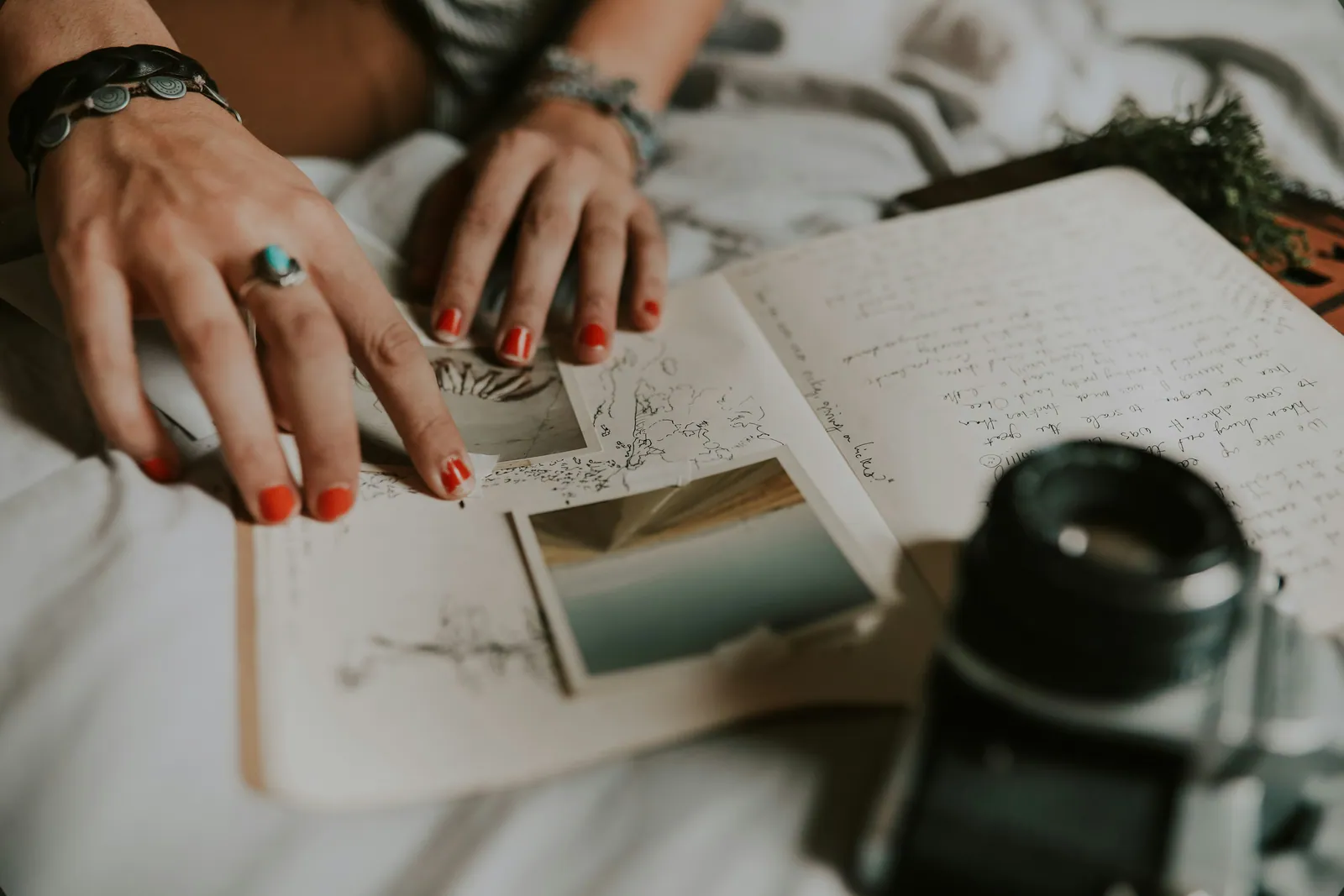 An adult writing in a journal beside a cup of coffee, taking a quiet reset moment