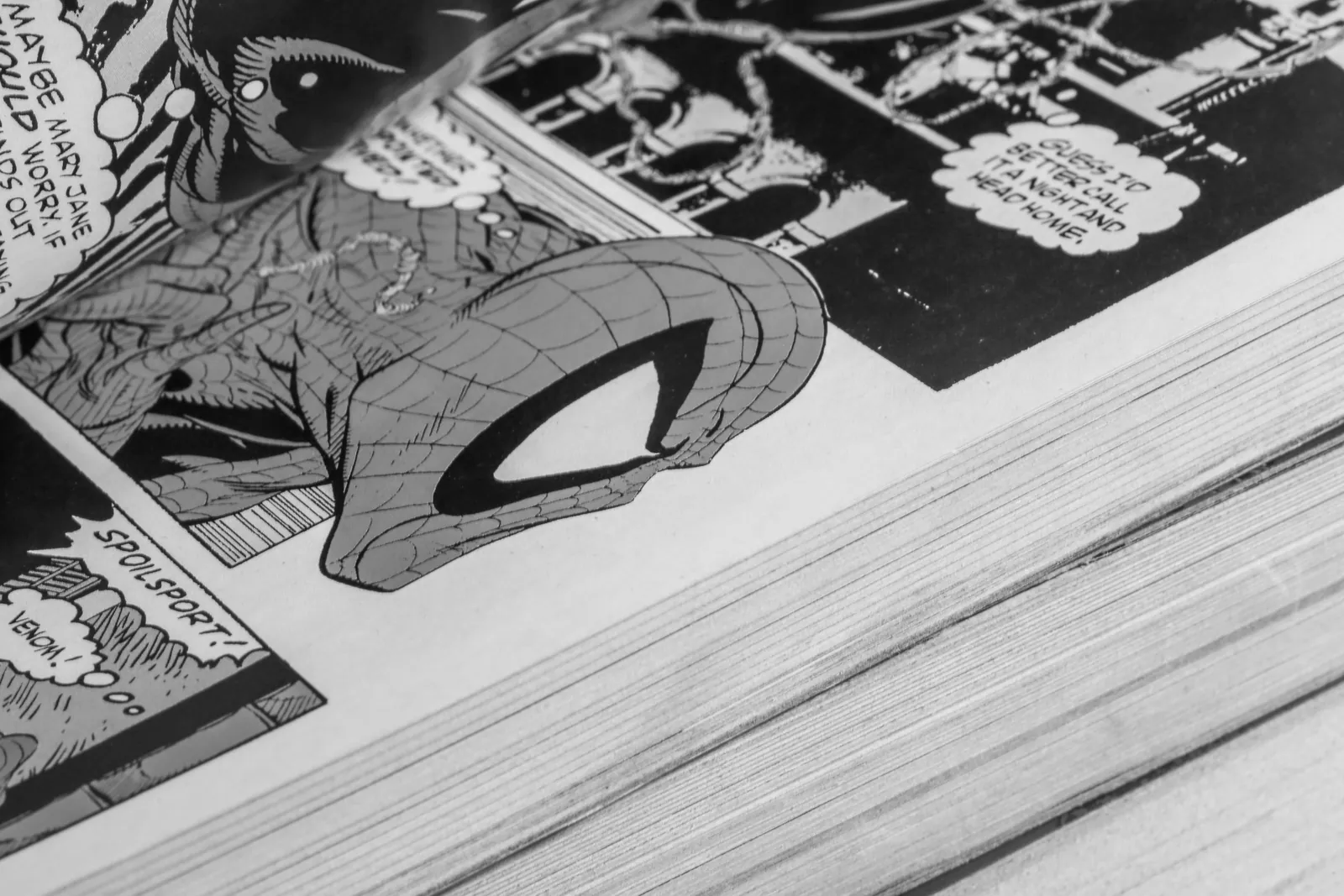 A close-up of a well-thumbed stack of comic books