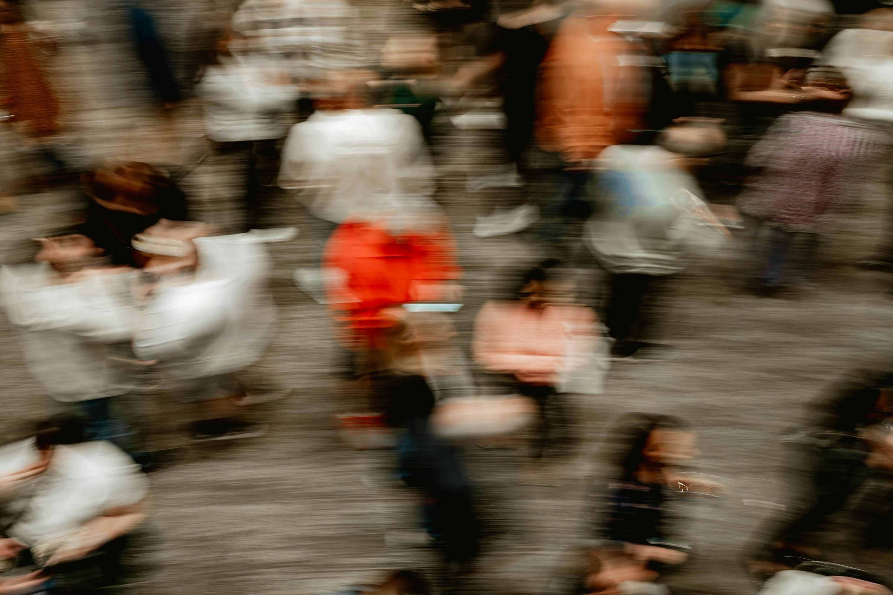 A blurred, motion-filled room of people at a busy social gathering