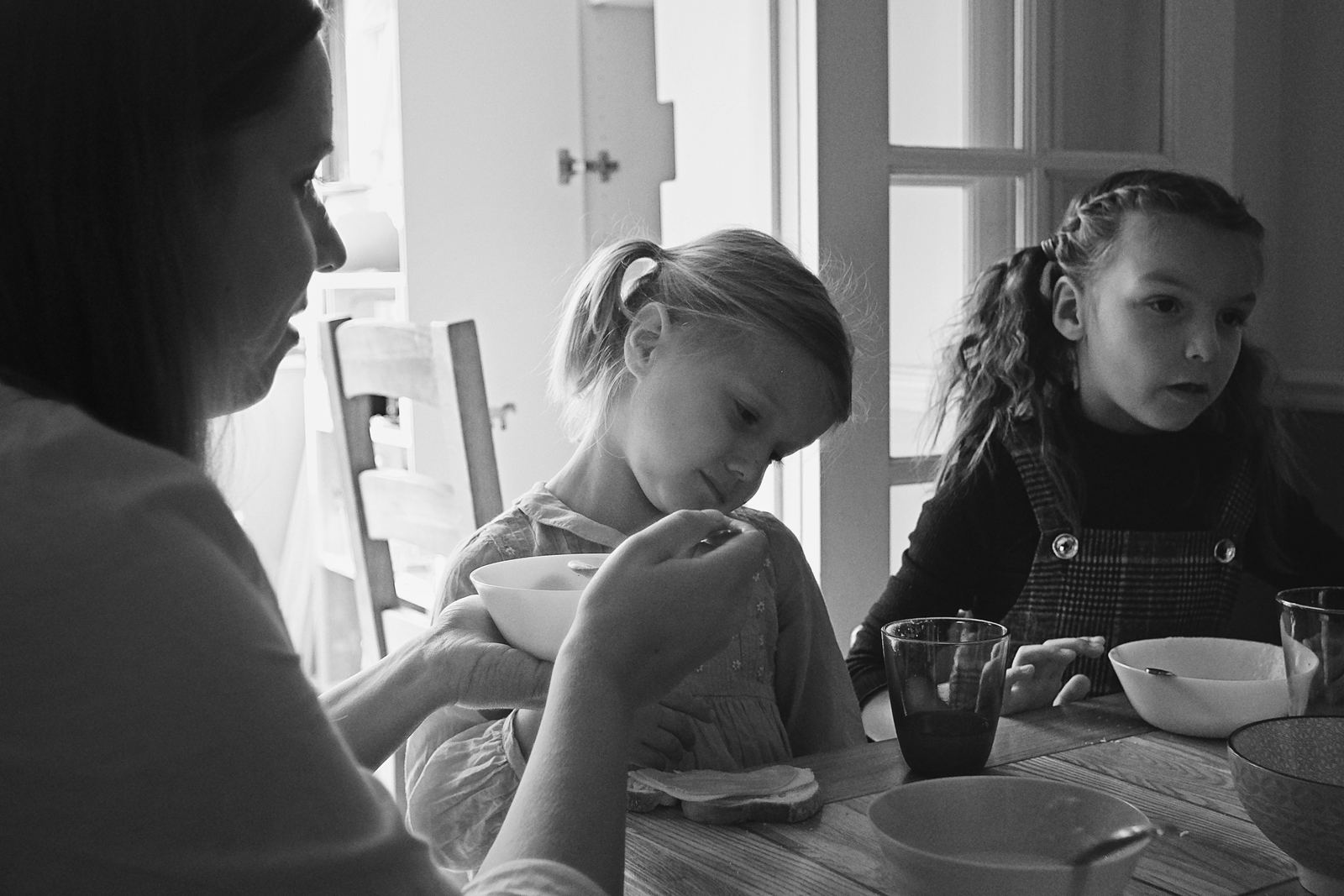 Two children sitting quietly at a kitchen table