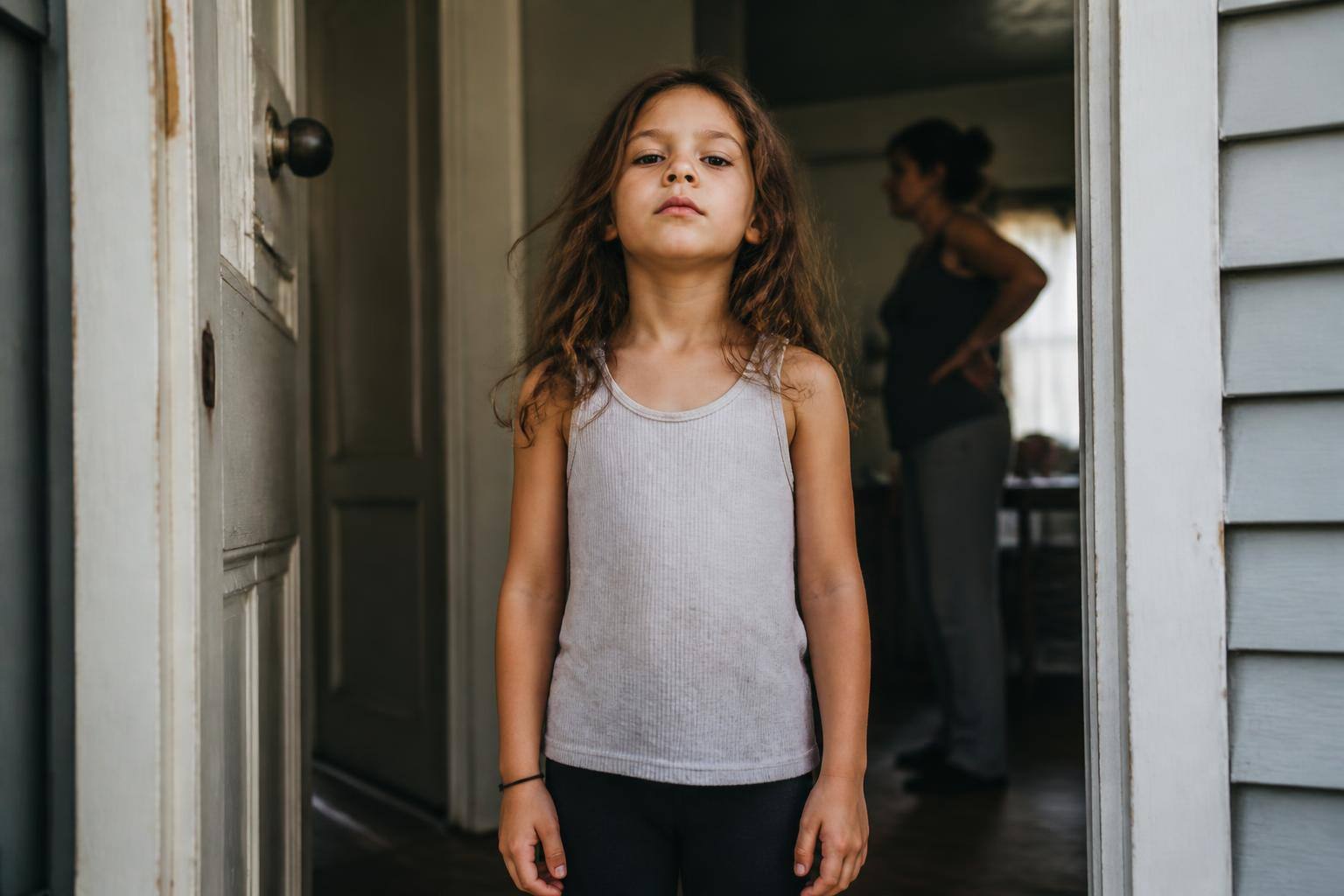 A girl of about seven standing confidently in a sunlit hallway in an outfit she has clearly chosen herself