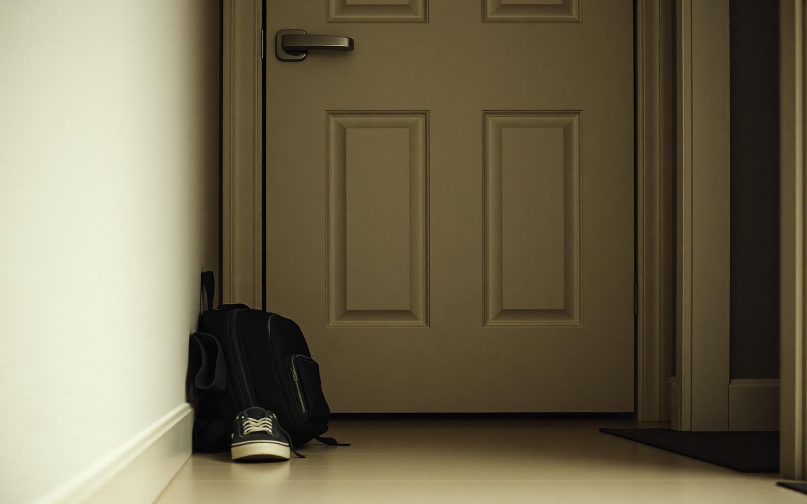 A child's backpack and favourite toy sitting on a hallway bench between two front doors